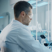 Cropped image of a scientist analysing a DNA sequence to represent AIBL's researchers.